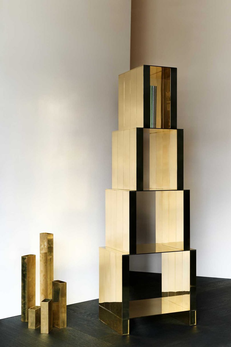 solid brass bookshelf made of stacked boxes atop one another