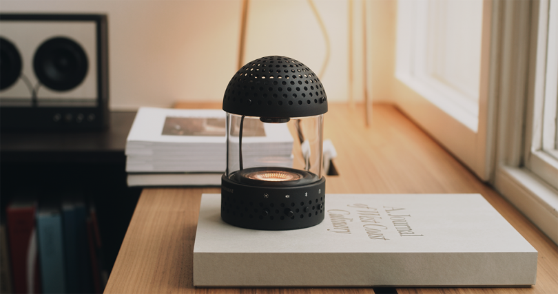 speaker/lantern combo sitting on a book