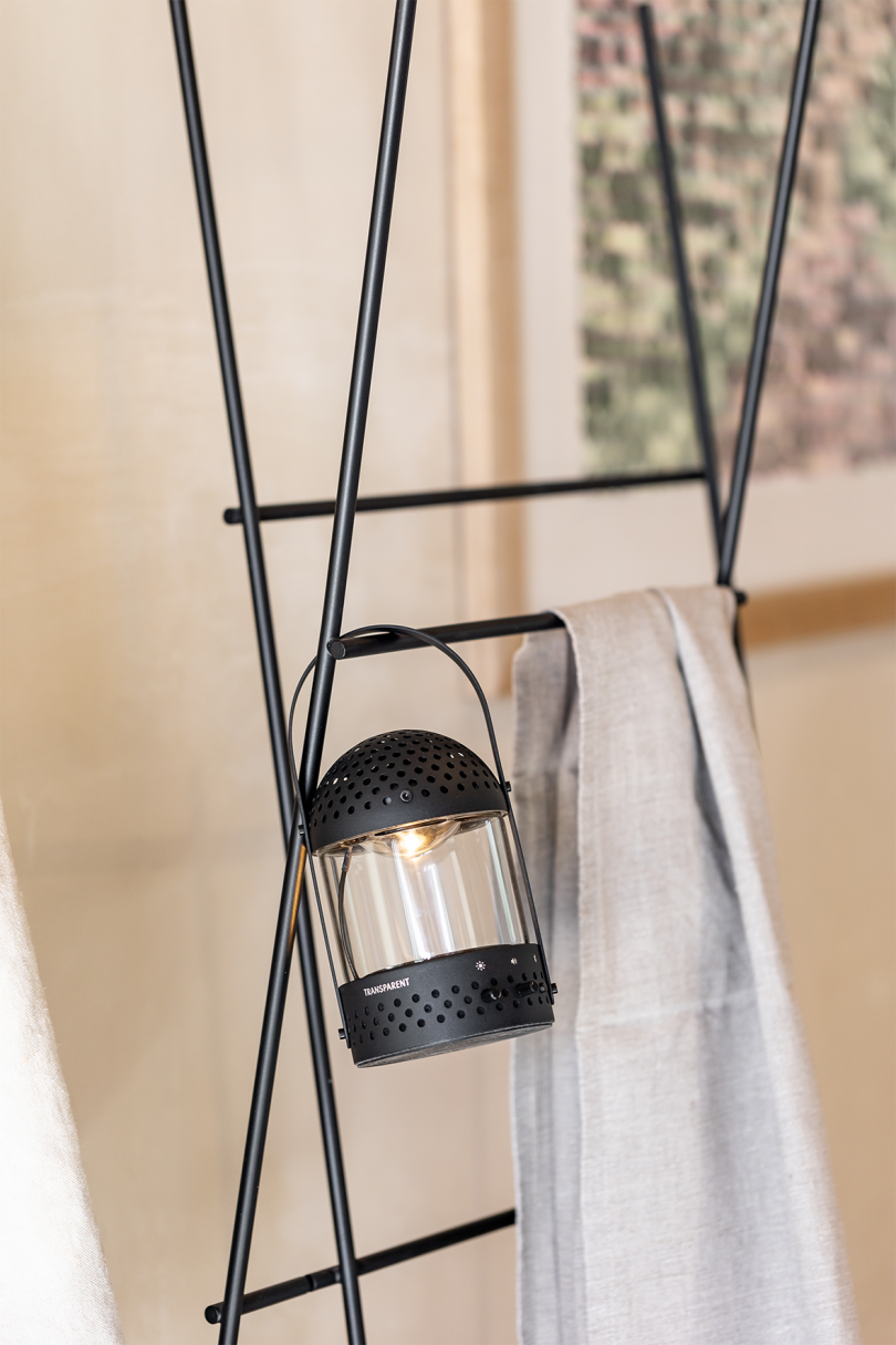 lit speaker/lantern combo hanging on blanket ladder