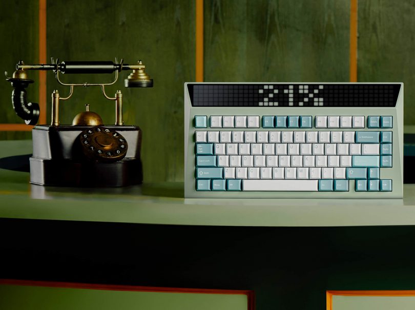 Light green mechanical keyboard with old dial-up telephone on its right side.