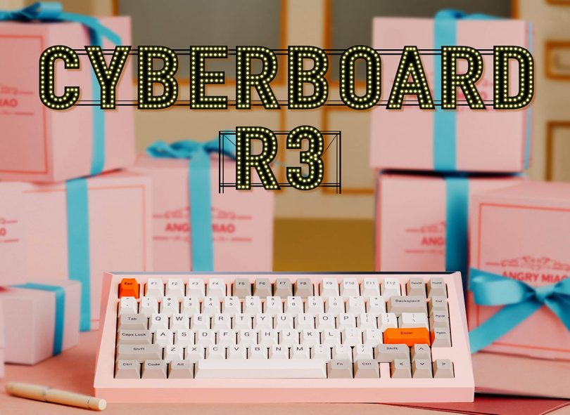 Pink mechanical keyboard with small gift boxes with blue ribbons stack in the background.