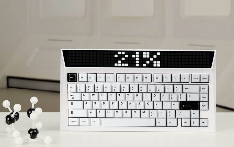 Black and white keyboard with models of molecules nearby.