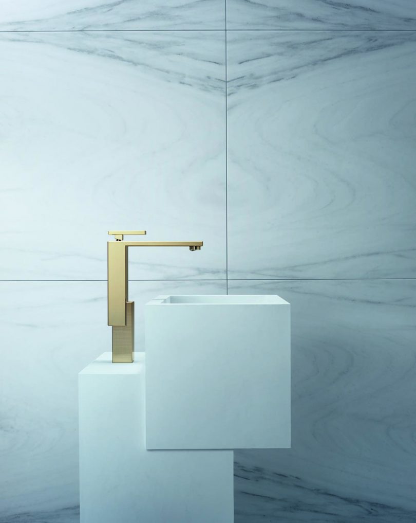 gold sink faucet on white sink