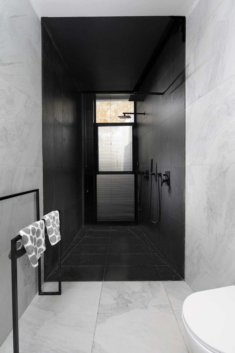 white and marble modern bathroom with black shower