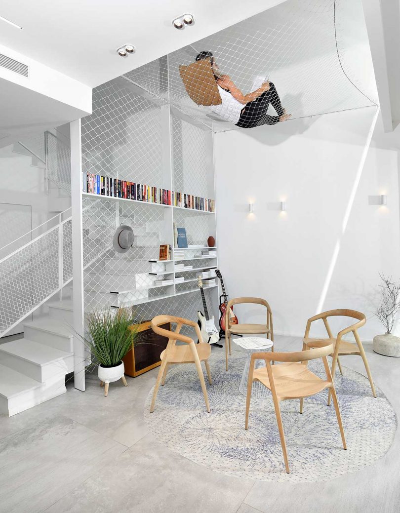 modern sitting area with stairs and open net hammock above