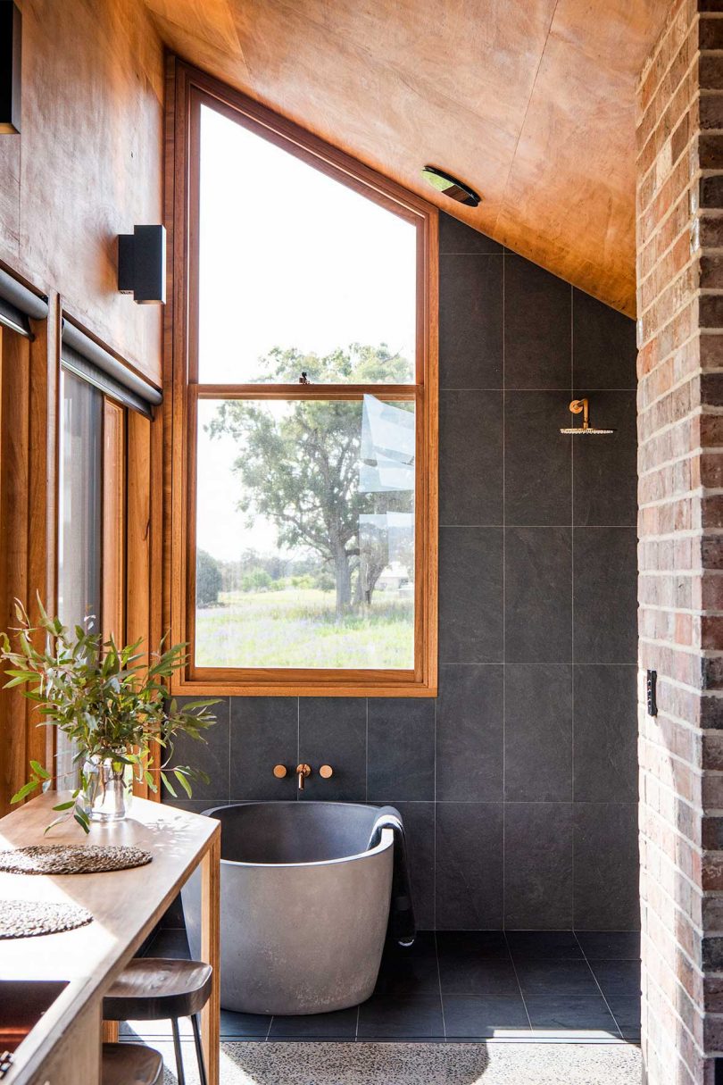 view of modern bathroom with slate tile walls and bathtub