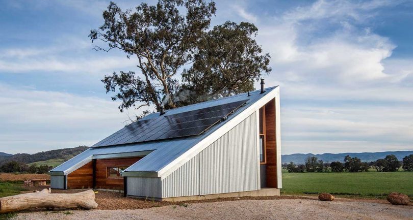 daytime shot of angular cabin with solar panels