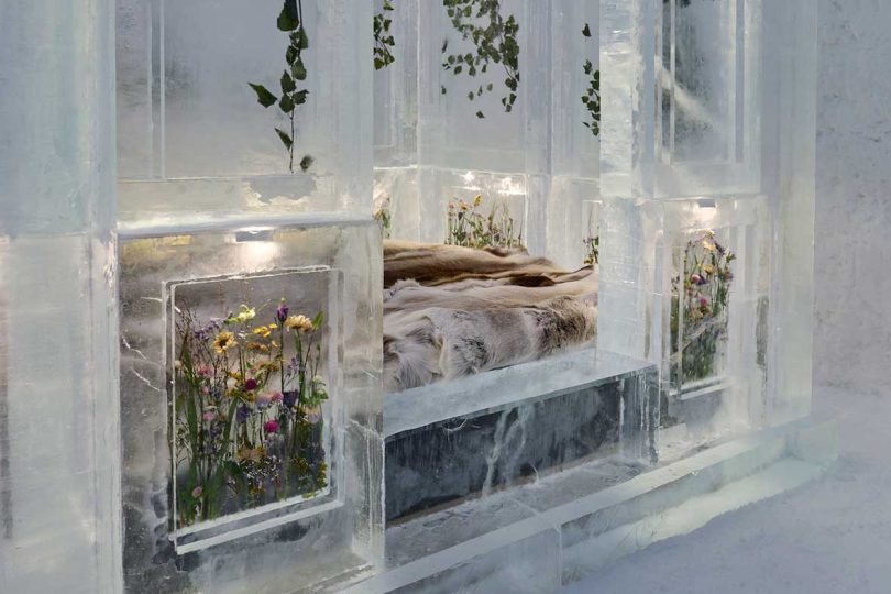bed surrounded by ice blocks in a new suite at the Icehotel