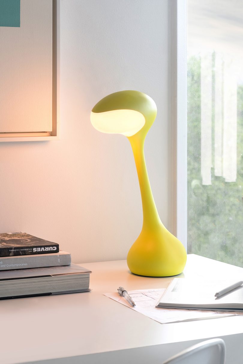 yellow task lamp on white surface in living space