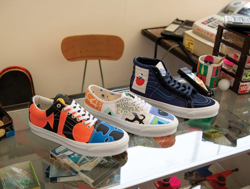 Three of the Vans Vault sneakers displayed across a glass countertop.