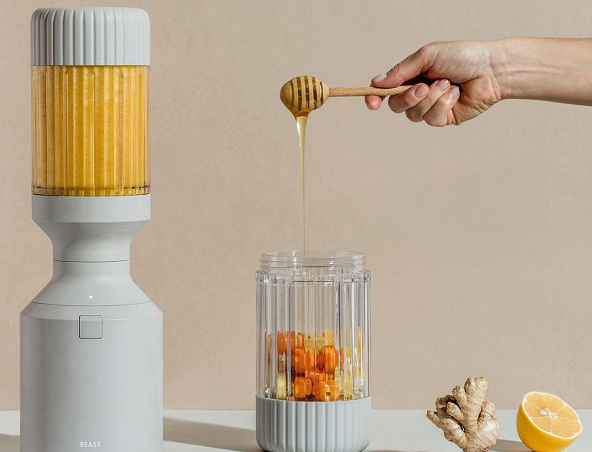 beast blender with hand adding ingredients
