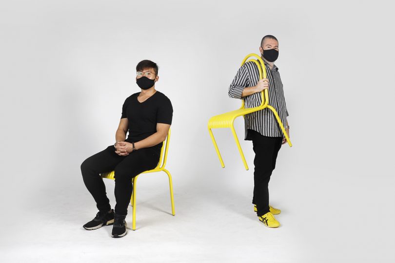 two people wearing black face masks with yellow outdoor dining chairs on white background