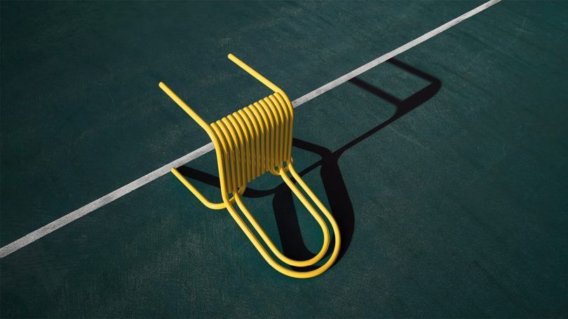 yellow outdoor dining chair laying on its back on tennis court