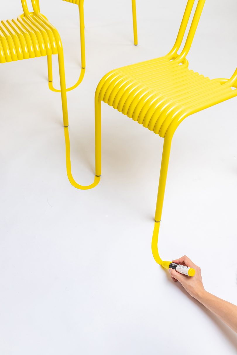 two yellow outdoor dining chairs being connected with yellow marker line