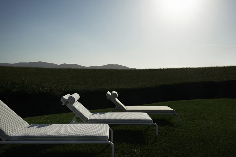 three outdoor chaise lounges in a row