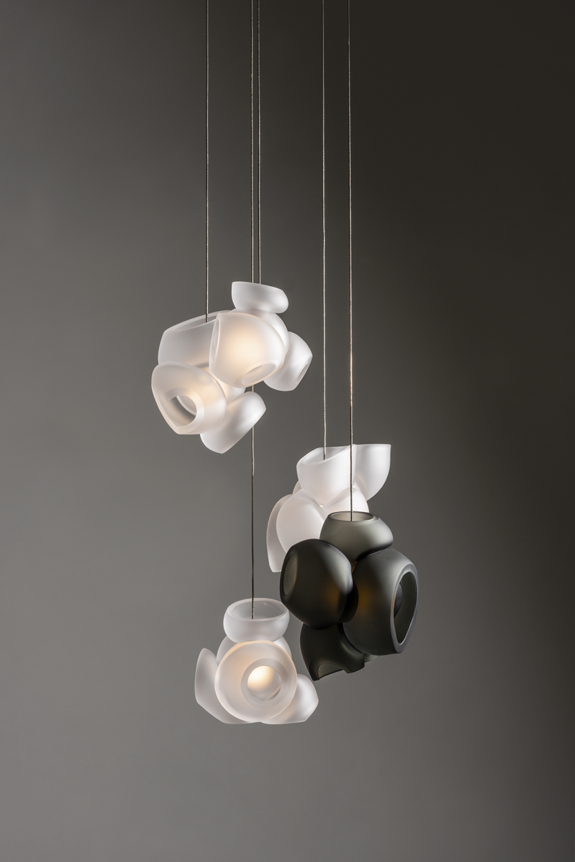 black and white glass light fixture against dark grey background