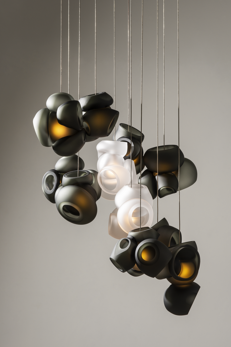 black and white glass light fixture against dark grey background
