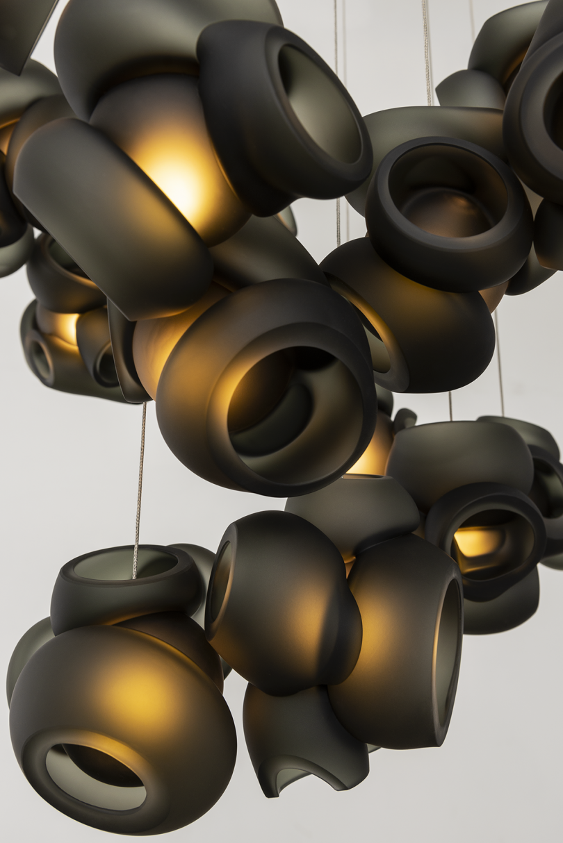 black glass light fixture against grey background