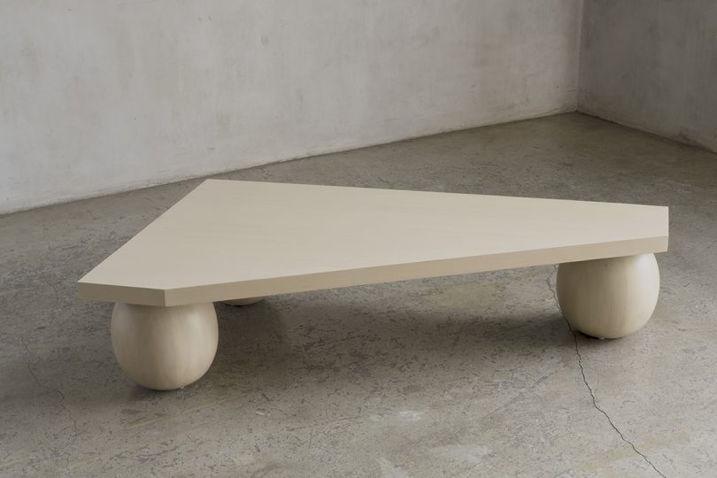three legged light wood coffee table