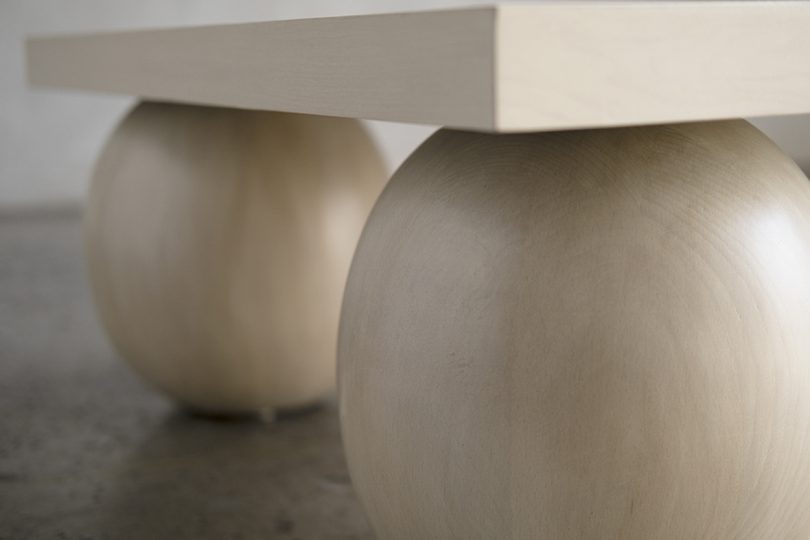 detail of three legged light wood coffee table