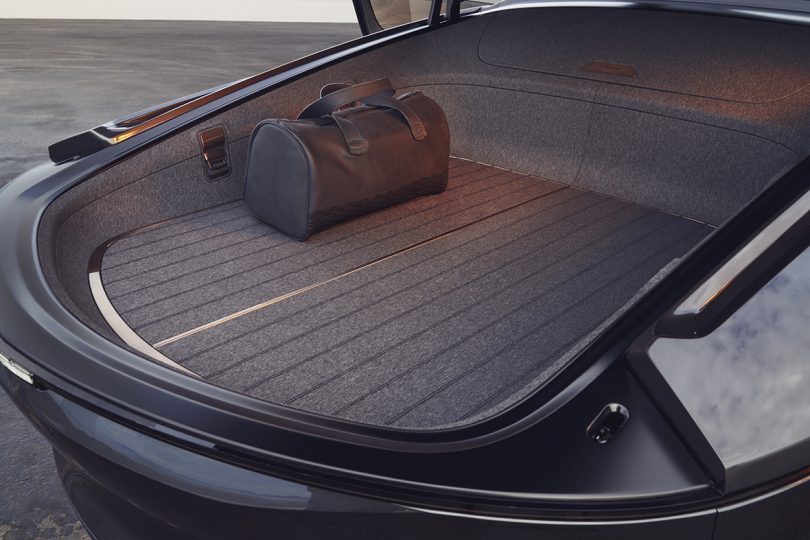Hatchback trunk section opened with small duffle bag in corner.