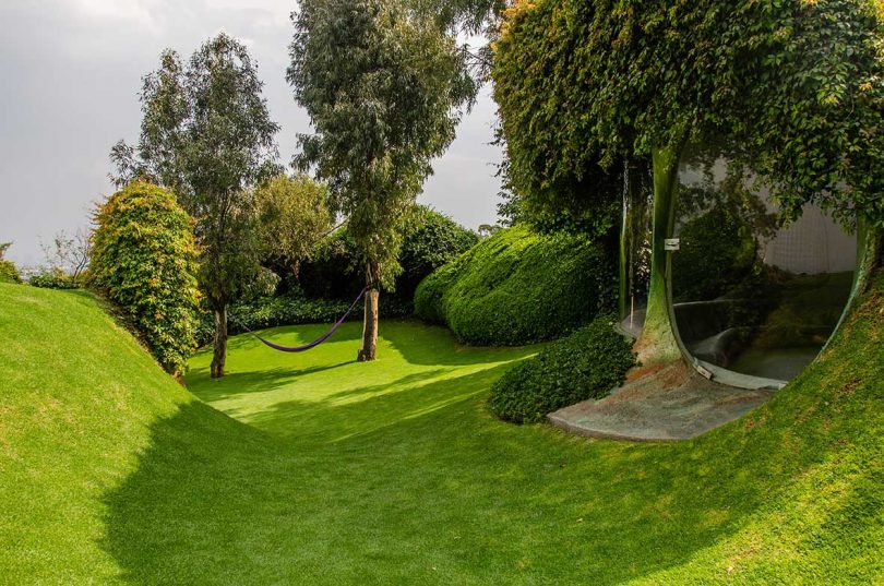 lush green landscaping with view of underground house