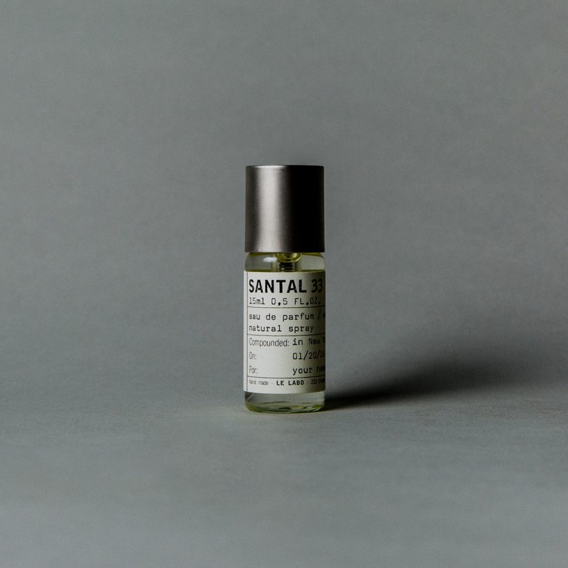 vial of perfume on grey background