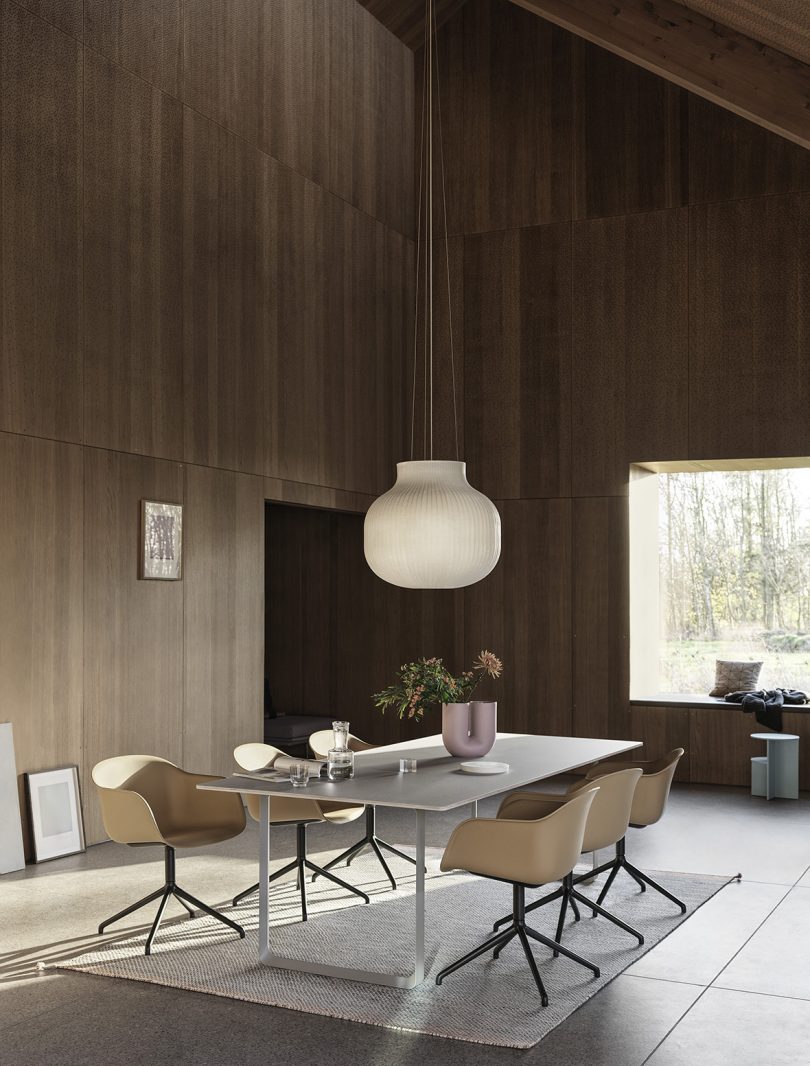 dining table surrounded by shell armchairs