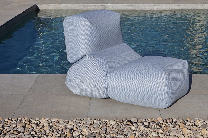 overstuffed chair next to a pool