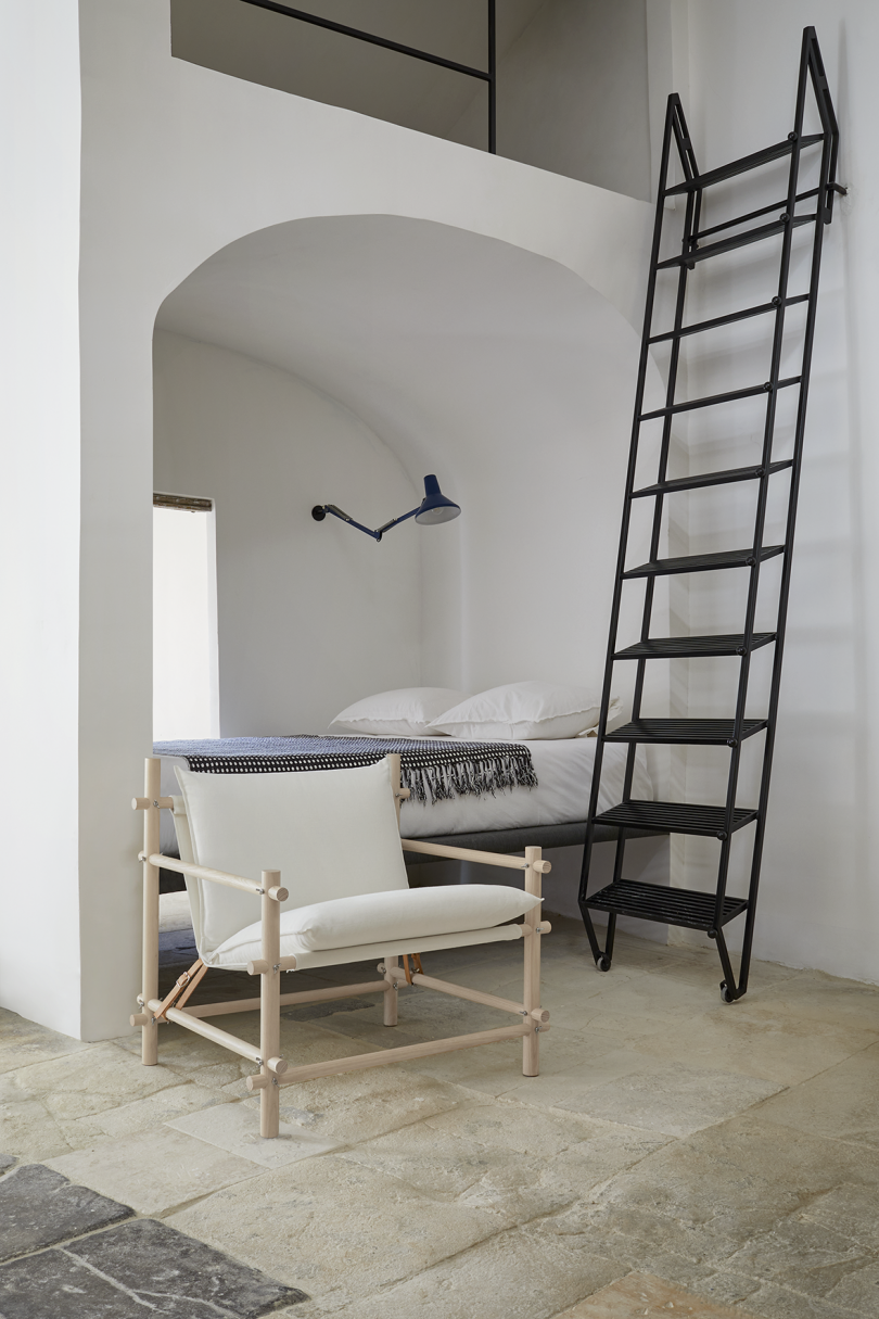 interior space with white armchair and ladder