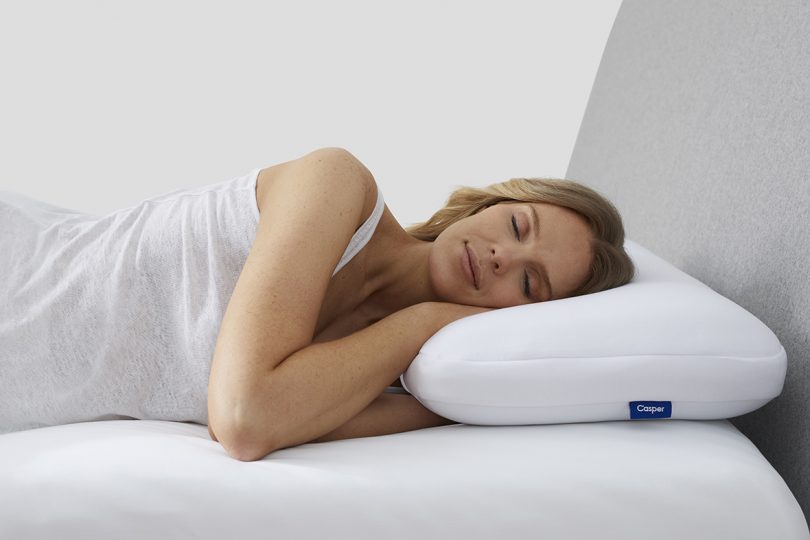 light-skinned woman sleeping on white pillow