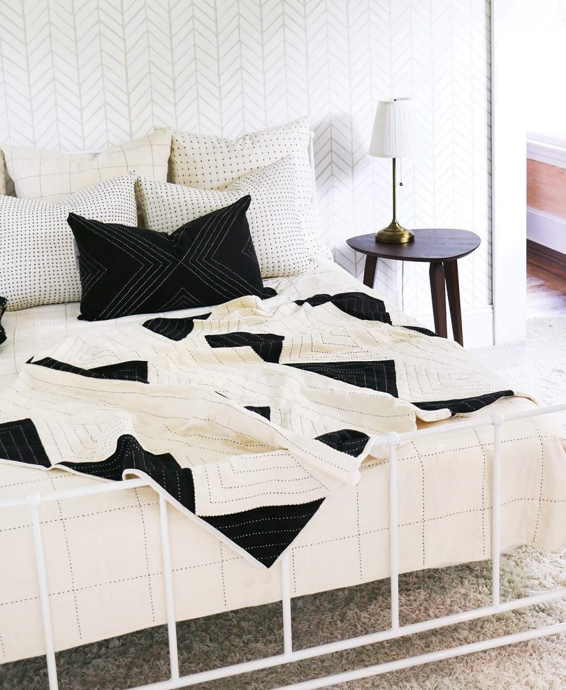 bed with black and white bedding and pillows