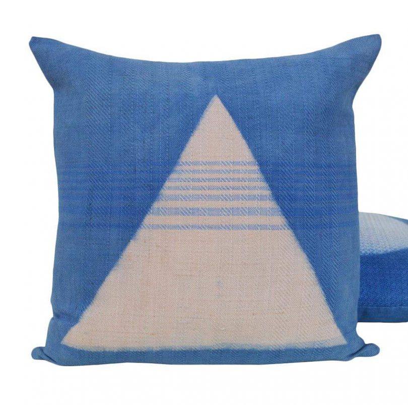 blue and white throw pillow on white backgrouond