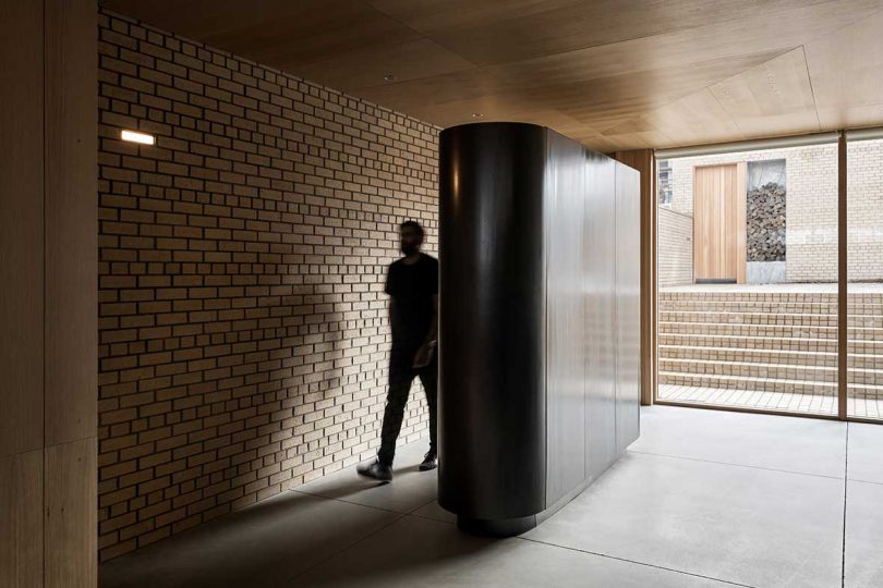 man entering modern house through corridor
