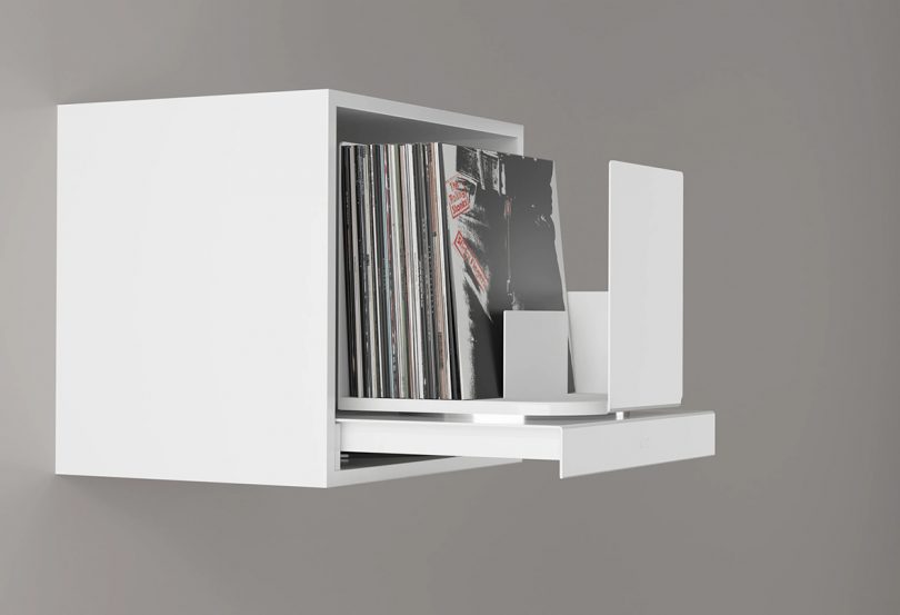 White cube record storage shown with drawer and record holder open with 12" records on display.