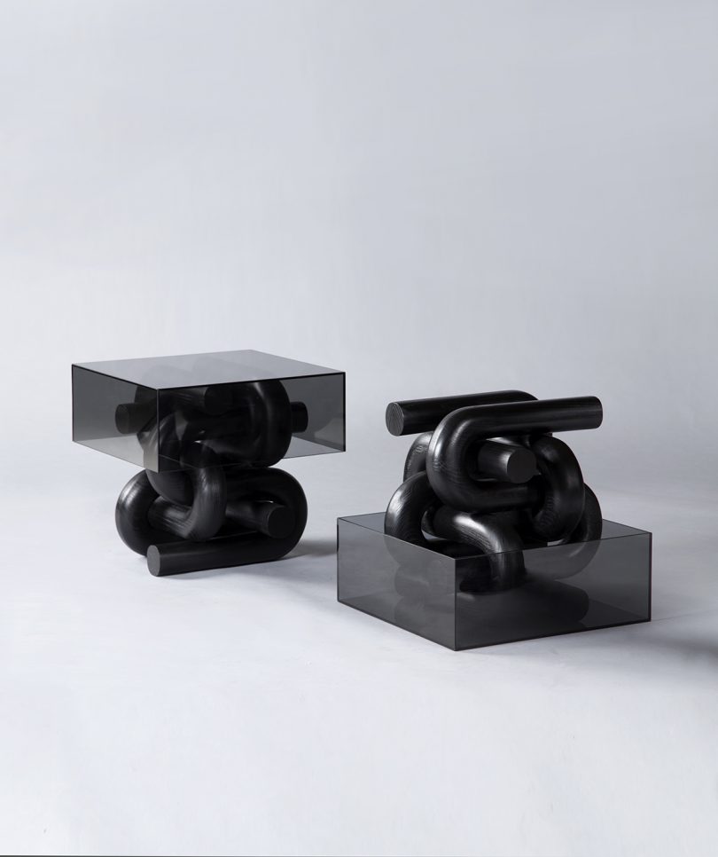 two abstract black sculptural side tables