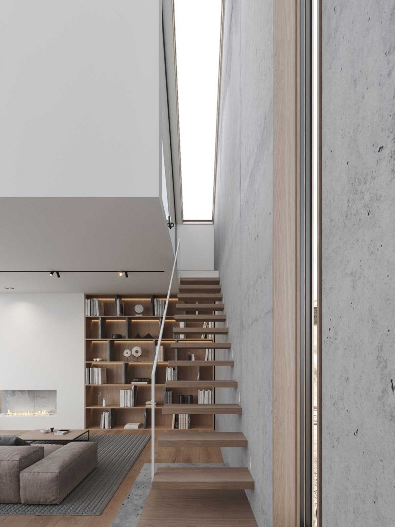 view of floating staircase in modern living room with large bookcase behind it.