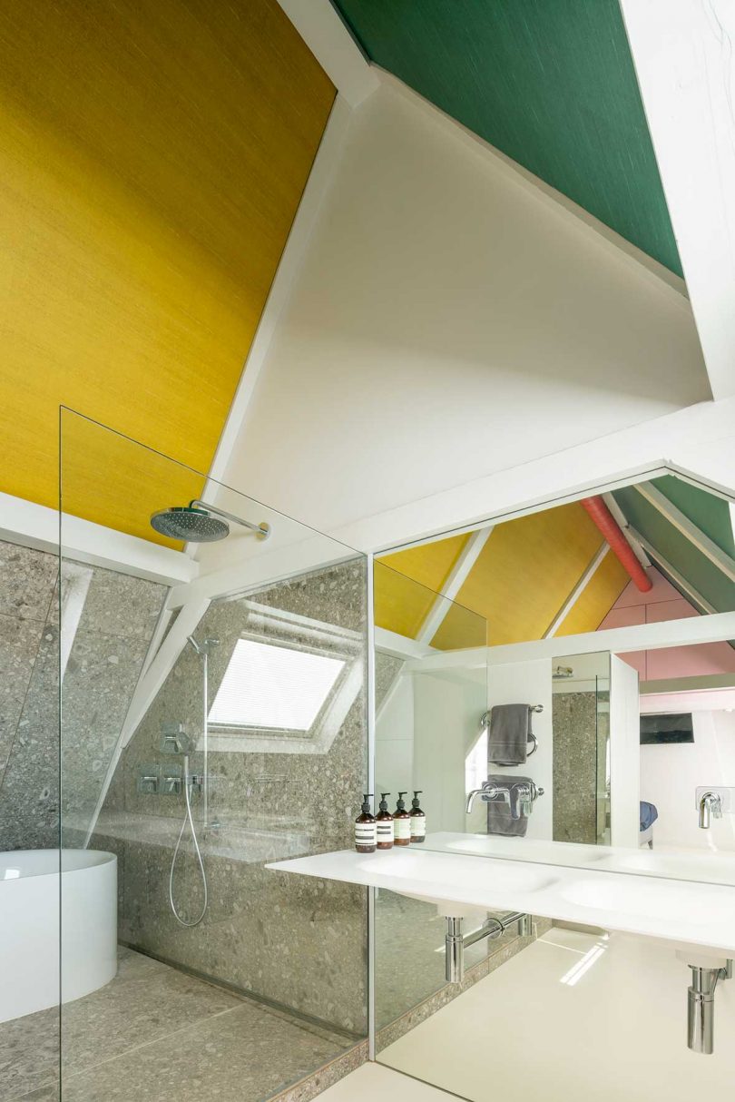modern loft interior bathroom with colorful pitched ceiling