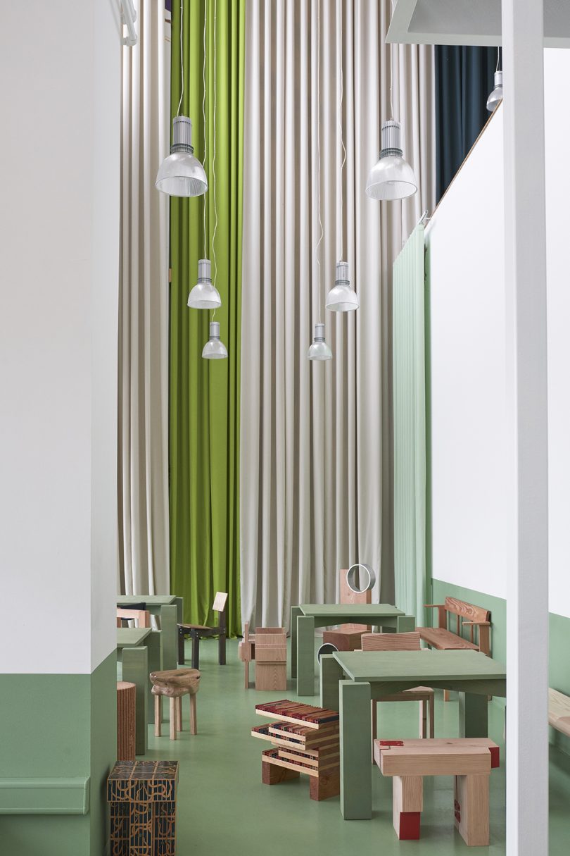 olive green and white cafe space with wood furniture
