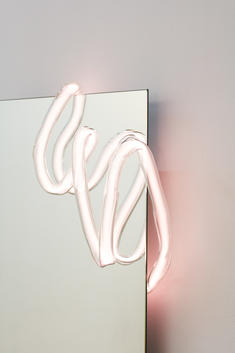 corner of white rectangle with squiggly neon light in upper right corner