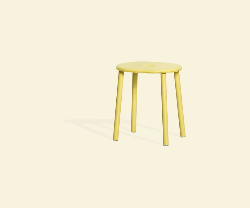 yellow stool on cream colored background