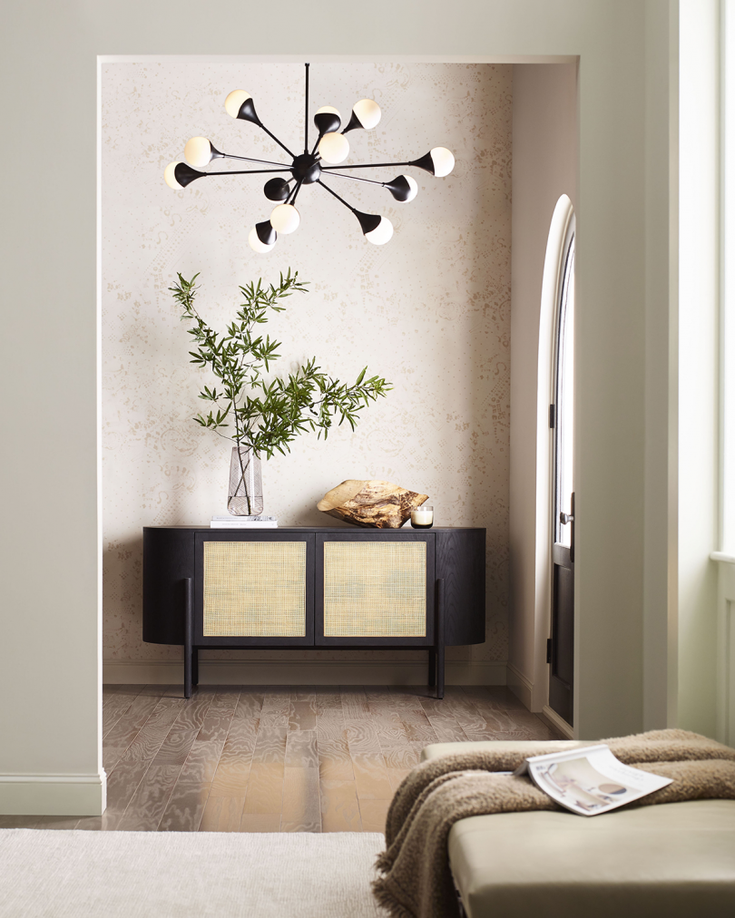 entry way with credenza, vase, and large light fixture