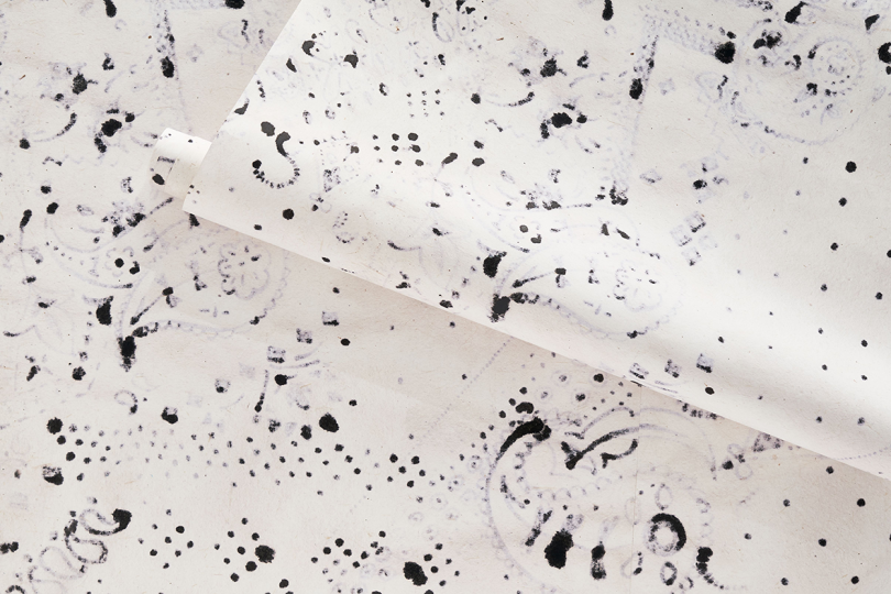 detail of wallpaper featuring dark abstract splotch pattern