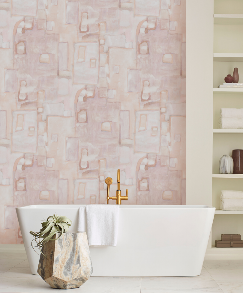 bathroom with soaking tub in front of wall of pink abstract watercolor wallpaper