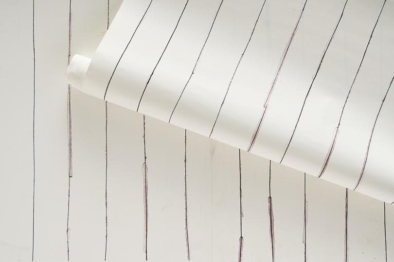 detail swatch of wallpaper featuring thin hand drawn stripes