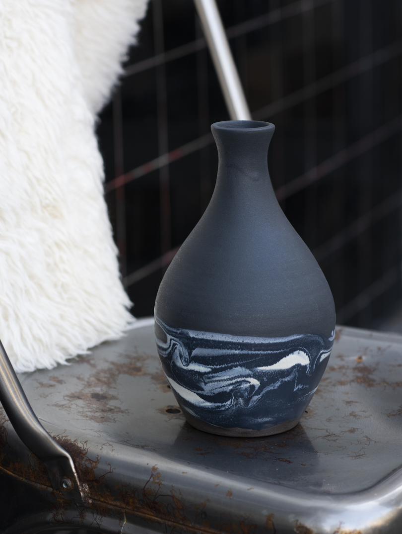 black ceramic vase with bottleneck and marbled base