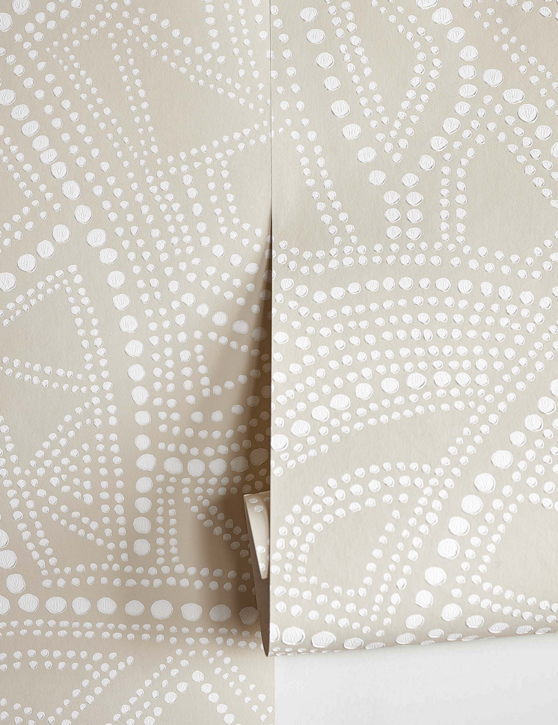 detail of light tan patterned wallpaper roll