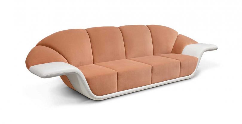 white and peach four-seat sofa with curved arms on white background