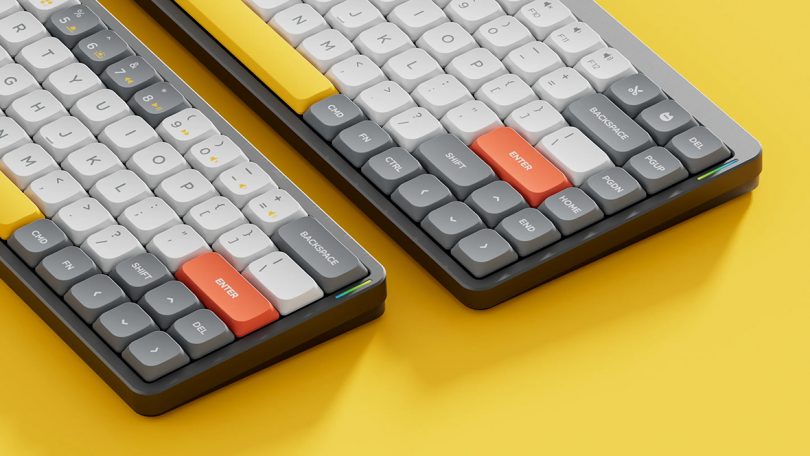 Side by side comparison of Nuphy Air60 keyboard to slightly larger Nuphy Air75 against yellow surface.