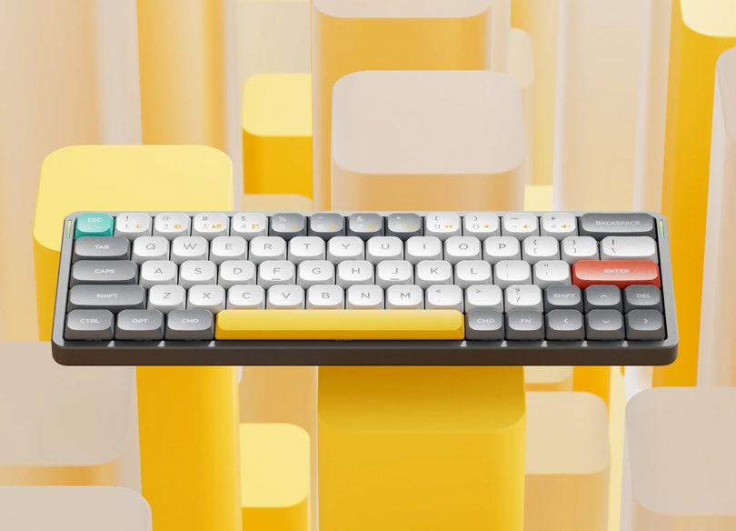 Nuphy Air60 mechanical keyboard shown against patterned yellow background.